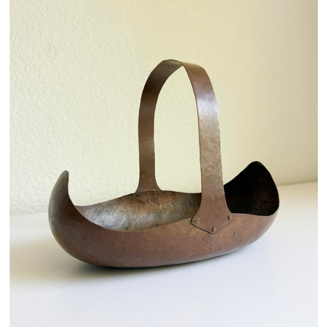 We present to you an original Arts and Crafts period hand-hammered copper "Canoe" flower basket attributed to the renowned...