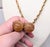 1960s goldtone two spherical resin "peach" tan moonglow drops with goldtone leaves around the tops necklace with spring...
