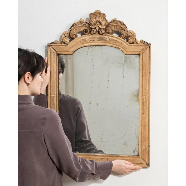 A mirror whose natural carved oak frame with shell crest, arched gives it real character at first glance. The piece dates...
