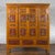 A Chinese Qing Dynasty period wide and large cabinet from the 19th century, with hand-carved and gilt panels. Created in...