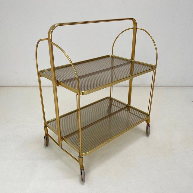 Folding serving cart made of metal and plastic in Germany in the 1960s.