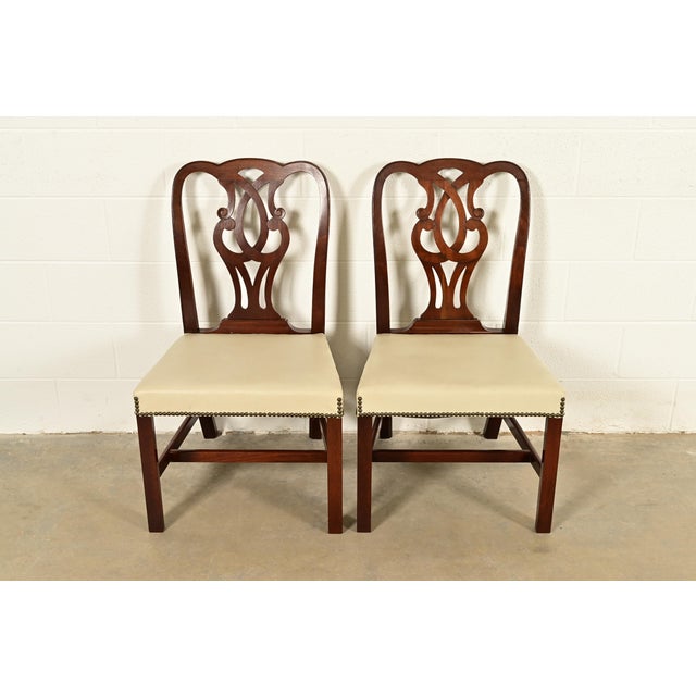 An outstanding pair of Georgian or Chippendale style side chairs or dining chairs By Baker Furniture USA, Circa 1980s...