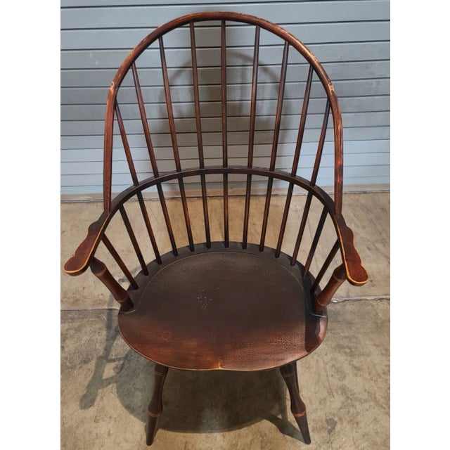 Chair has a bent back with spindles with rail back support, shaped arms with carved paddles, carved shield seat resting on...