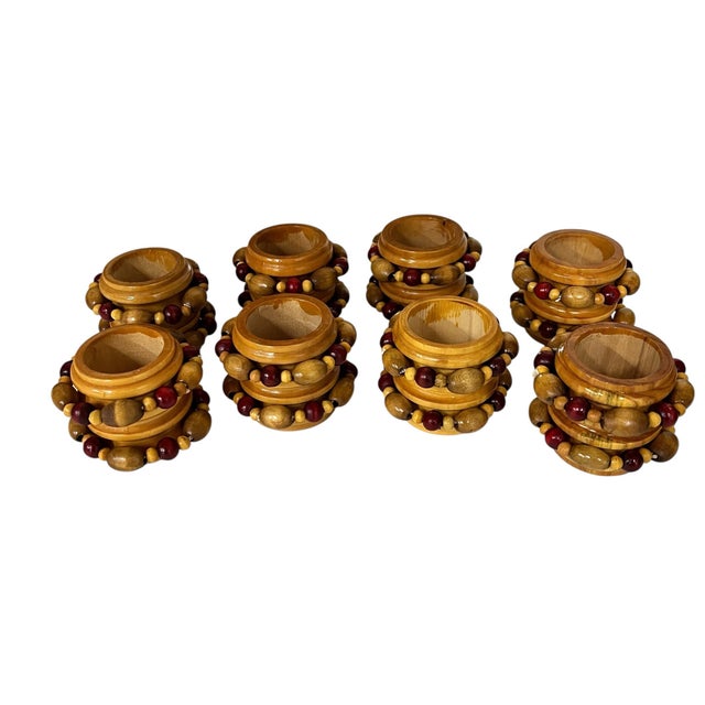 Handmade wooden napkin rings with hand strung beaded border. Red beads accentuate the natural shades of wood. Displays...