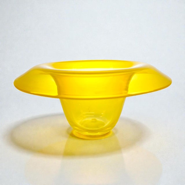 Handblown art glass bowl from Studio Åhus, Sweden, dated 2008. This vibrant yellow piece features a wide, sculptural rim...