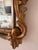 A beautifully aged Rococo-style giltwood mirror, carved in high relief with flowing acanthus leaves, C-scrolls, and a...