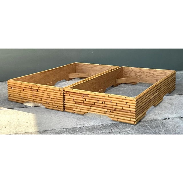 This vintage pair of bed bases is built as two low, open rectangular frames, each wrapped in a dense horizontal stack of...