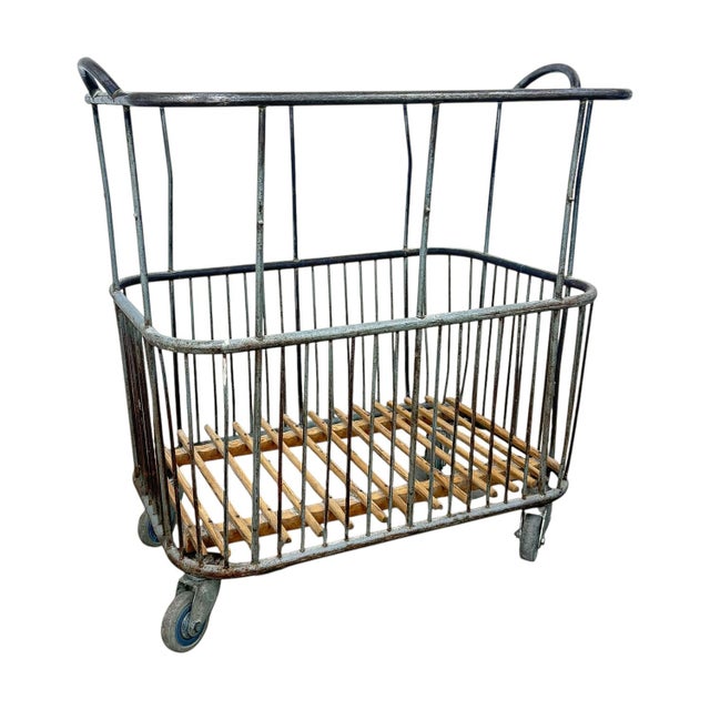 Authentic vintage French bakery cart made of metal with wooden slatted base and original industrial castors. Originally...
