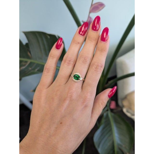 A 1.8-carat tsavorite garnet blazes in vivid, grass-green at the centre of this solid 14K yellow gold ring, set east-west...