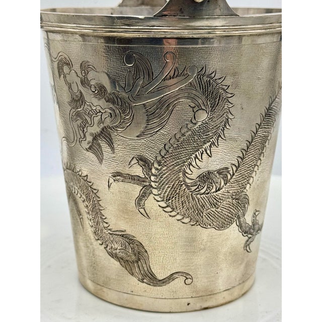 This Antique Chinese export NanKing Store silver ice bucket is complete matching tongs. The bucket is decorated with a...