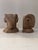A pair of ram head bookends crafted in faux stone composite, featuring intricate horn and fleece detailing that gives them...