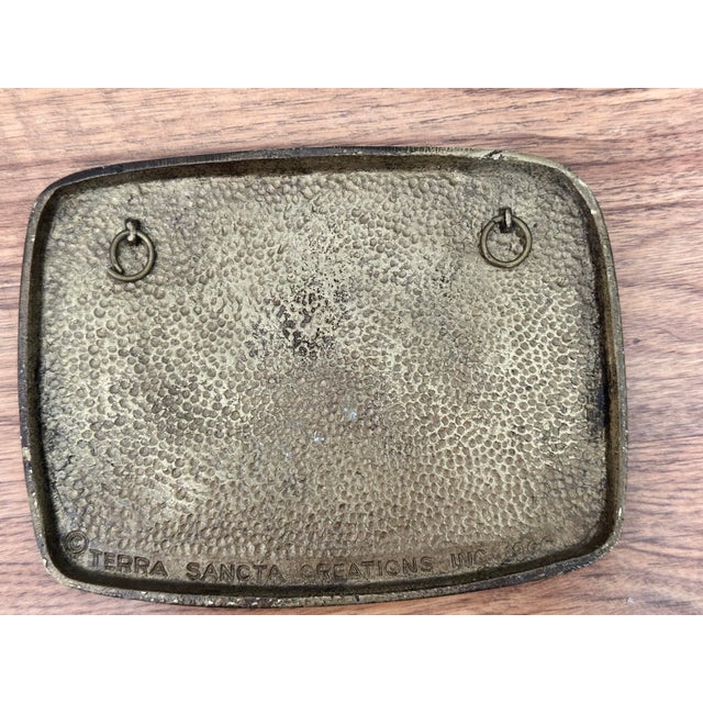 Mid-century cast brass wall plaque by Terra Sancta Creations, dated 1966. Features vibrant hand-painted enamel accents and...