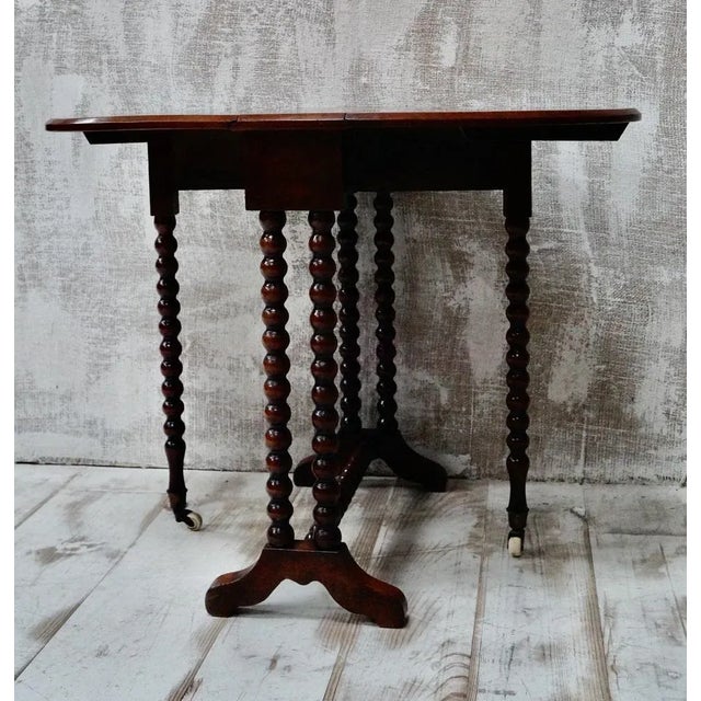 A Superb Victorian Walnut Bobbin Turned Gate Leg Table. Made from Walnut with two drop leaves that create an oval table...