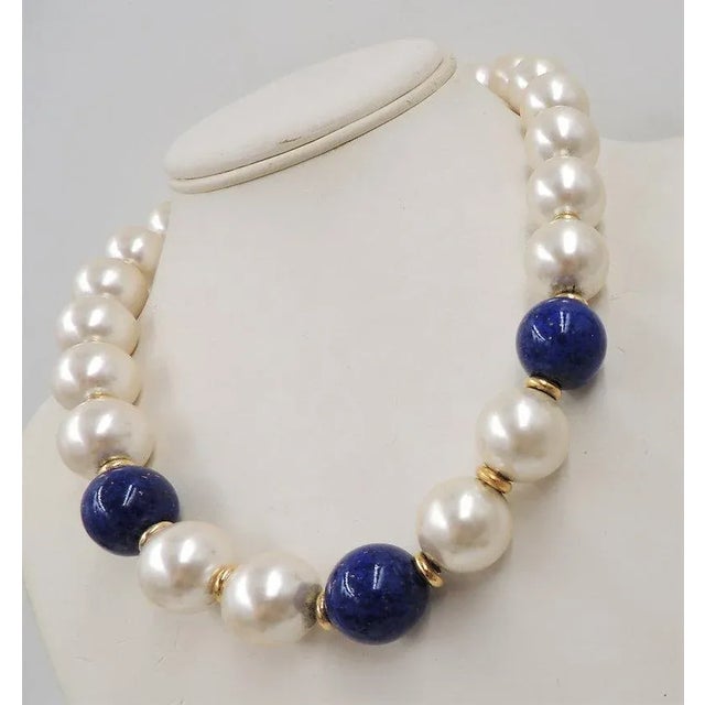 This is part of Chairish’s Costume Jewelry assortment. c. 1992 goldtone chunky mabe faux-pearl and faux-lapis necklace...