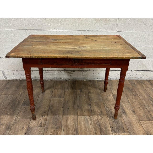 This is a gorgeous and rustic antique primitive wooden farmhouse table. It features a well-worn, natural wood top with...