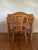 Vintage wicker writing desk or vanity with matching wicker chair. Desk features a curved back, two organizing pockets and...