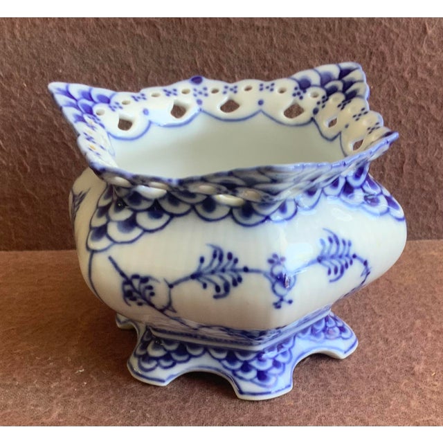 Features delicate reticulated lace work along the upper rim combined with cobalt blue hand painted floral designs.