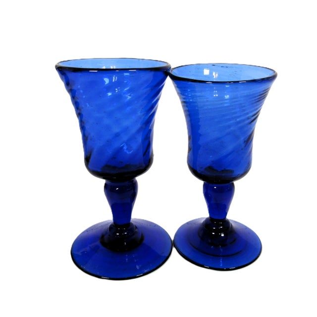 These are blown glass and individually hand made, which explains why they don't exactly match. One is slightly taller....