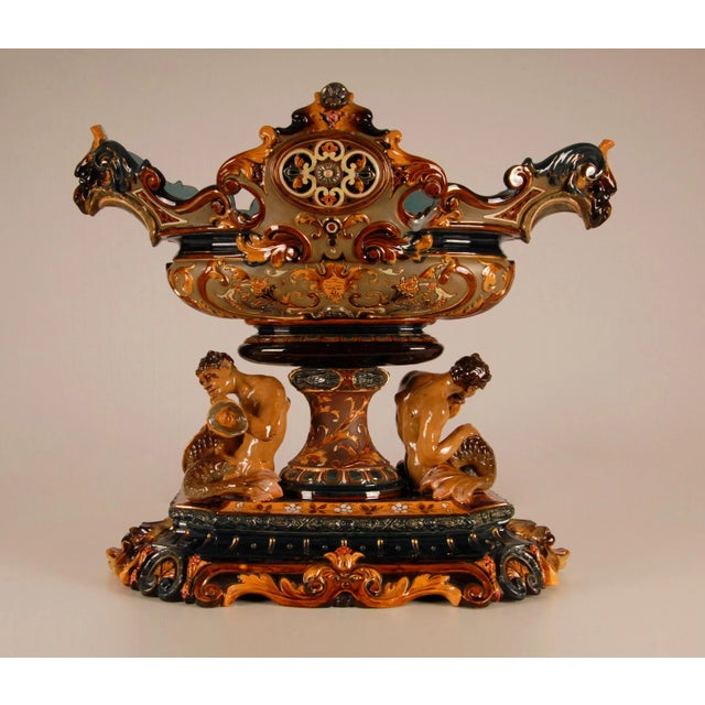 Antique 19th century majolica centrepiece / jadiniere Composed two Tritons blowing on a trumpet / horn The jardiniere is...