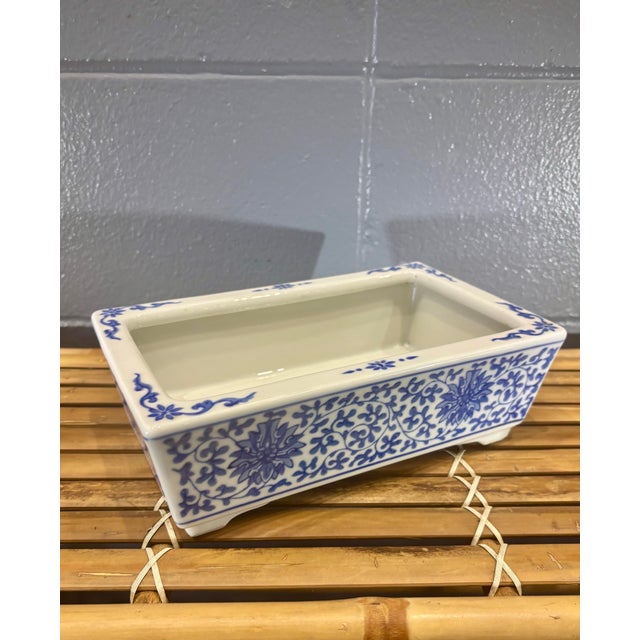 Beautiful vintage Chinese blue and white porcelain jardinière featuring a classic floral scroll motif inspired by...