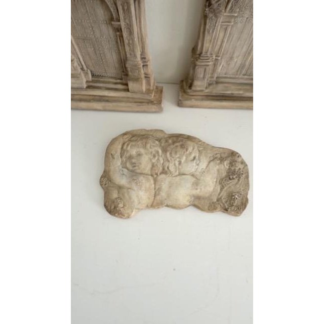 Set of three vintage plaster decorative reliefs featuring two ornate Renaissance-style architectural doorway plaques and...
