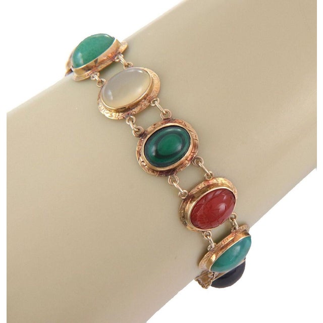 The Cabochon Multicolor Gems 14k Rose Gold Oval Link Chain Bracelet is a vintage piece of fine jewelry featuring a unique...