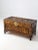 An early 20th century Chinese camphor wood chest featuring deeply carved panels of traditional sailing junks set against...