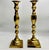 An elegant pair of tall, lacquered brass candlesticks featuring graceful, architectural silhouettes and the understated...