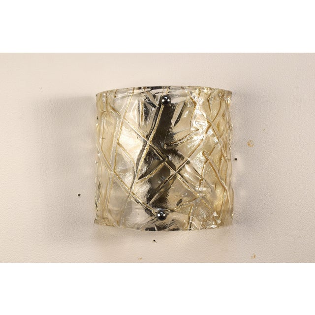 Pair of original Murano glass wall sconces from the 1970s, entirely handmade in Italy. The simple yet elegant design...