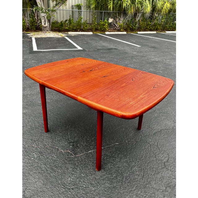 Mid-century modern danish teak extendable dining table with butterfly self-storing leaf. A sleek and streamlined design...