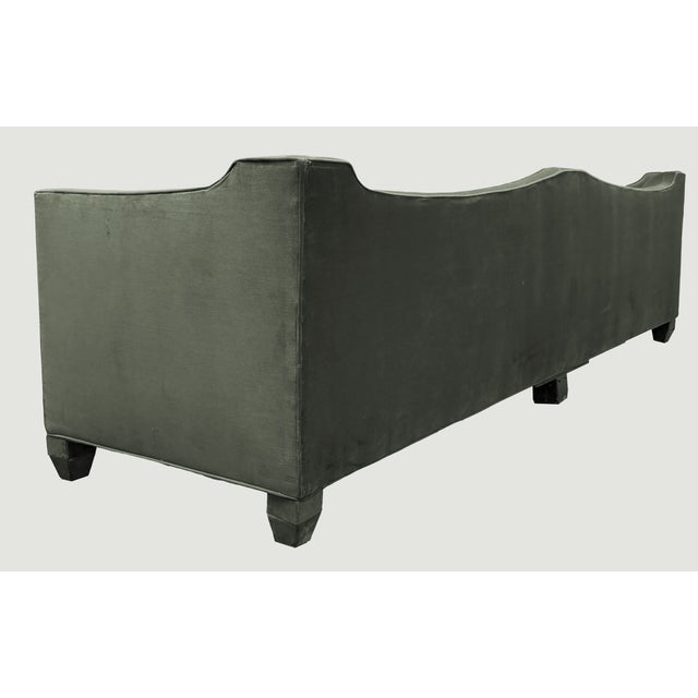 Statement-making tuxedo-style sofa with a channel-tufted "gondola" back — a nod to 1960s Hollywood Regency design....