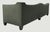 Statement-making tuxedo-style sofa with a channel-tufted "gondola" back — a nod to 1960s Hollywood Regency design....