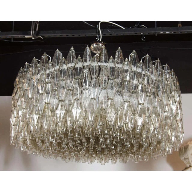 This impressive Italian chandelier consists of numerous polyhedral shades suspended in a complex interlocking cylindrical...