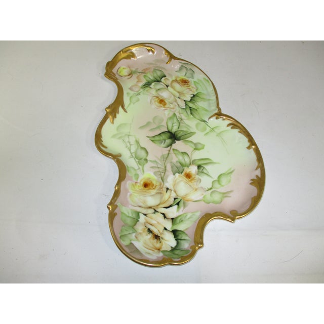A unique shaped antique dresser or serving tray. Made by the Tressemanes & Vogt Co.(T&V), Limoges France. It is made of...