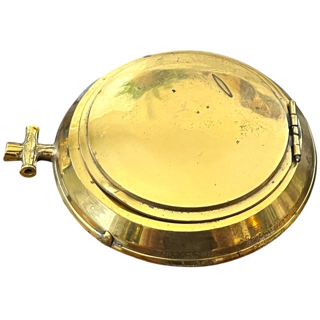 A wonderfully unusual vintage solid brass covered ashtray, dating to approximately the mid-20th century. The circular,...