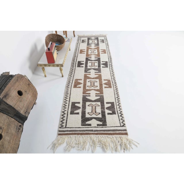 Vintage Turkish Hand-Knotted vintage rug is a semi-Vintage runner rug.'70s Eastern region of Turkey's unique rug is...