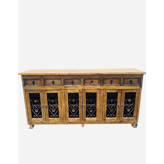 Fabulous sideboard with 6 doors and 6 drawers, solid wood with beautiful wrought iron design. No bad angles very heavy. A...