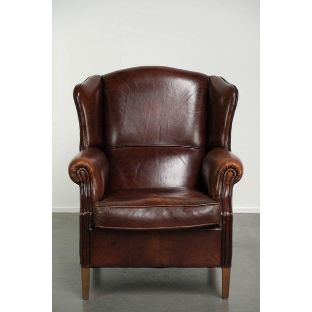 This stately sheepskin wingback chair features a beautiful, warm chestnut color and a comfortable seat. It comes with a...
