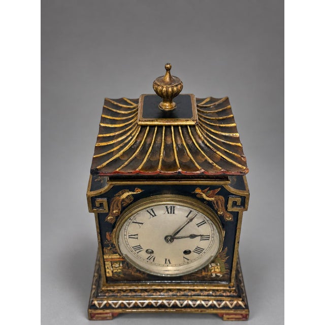 An English Edwardian mantel clock with a Coventry Astral movement, housed in a japanned wooden case of architectural...