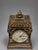 An English Edwardian mantel clock with a Coventry Astral movement, housed in a japanned wooden case of architectural...