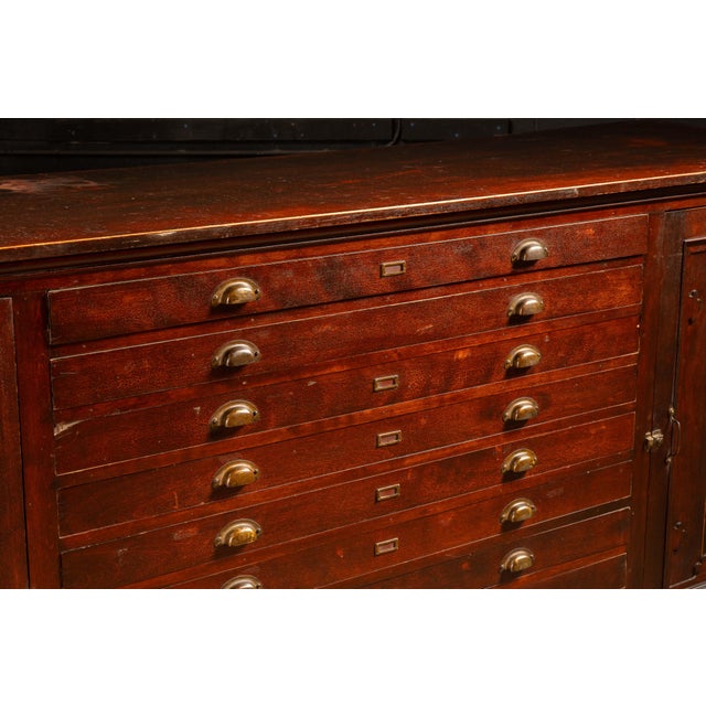 c. 1940s Vintage hardwood flat file cabinet with additional hideaway shelving. This impressive piece offers the same...