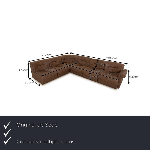 The sofa set from de Sede is covered with brown genuine leather and stands on simple feet. It is characterized by its...