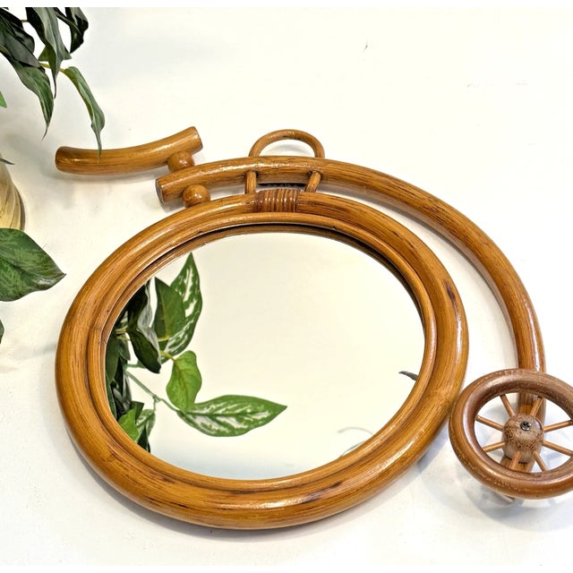 This whimsical wall accent mirror is made of bamboo. It measures 11" high, approximately 13" long, and weighs almost 14...
