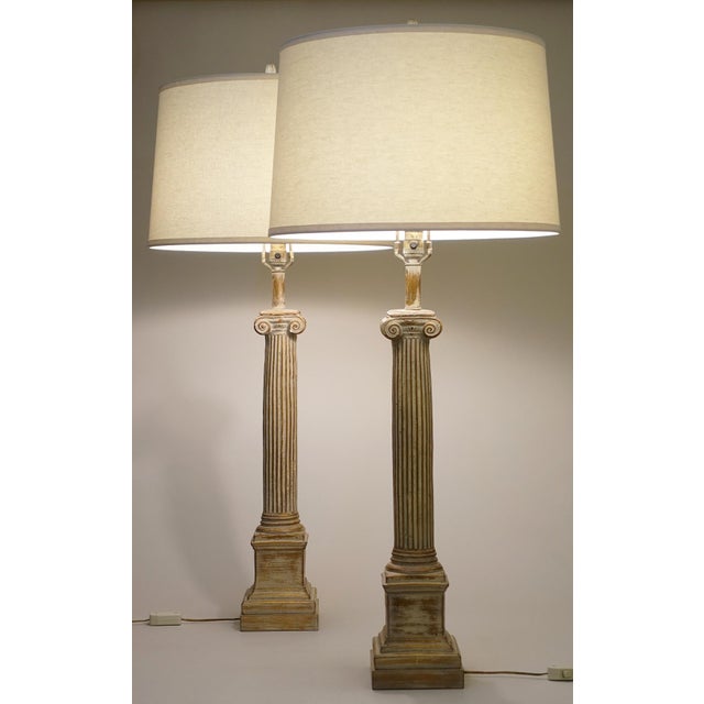 A striking matched pair of very Large ceramic plaster Classic Hollywood Regency Ionic Column style table lamps circa...