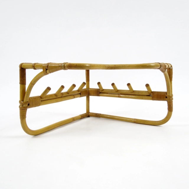 This coat rack features a bamboo frame with rattan details, and it is specially designed to be placed on a corner. The...