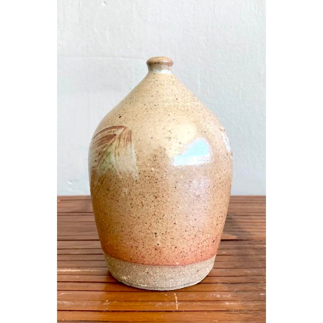 This petite studio pottery piece is a sculptural vessel crafted in the form of a bud vase, though sealed at the top and...