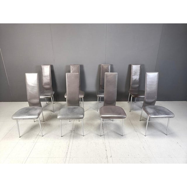 Set of 8 dark grey leather and chromed frame dining chairs designed by Giancarlo Vegni for Fasem italy. The chair seat...