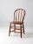 This is an antique bow back Winsdor chair. The classic farmhouse dining chair has a round spindle back. Beautiful patina...