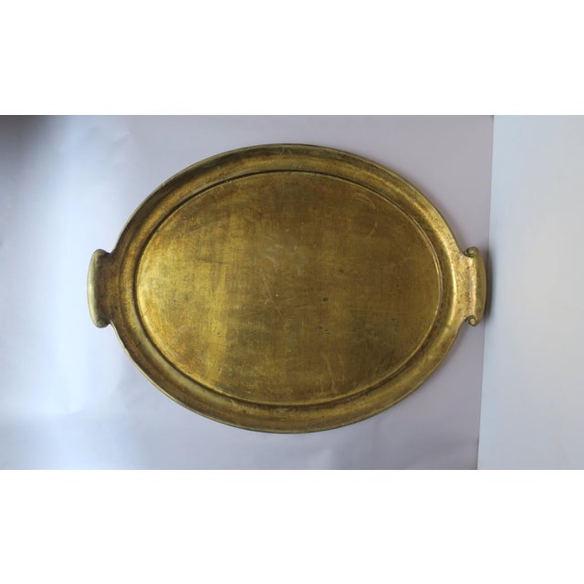 *Two available, each sold separately. An Italian oval gold giltwood serving tray with handles, circa late-20th century,...