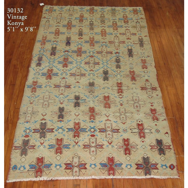 A vintage one of a kind Turkish Anatolian rug with a all-over repetitive design on a bone colored field. 5'1' x 9'8''